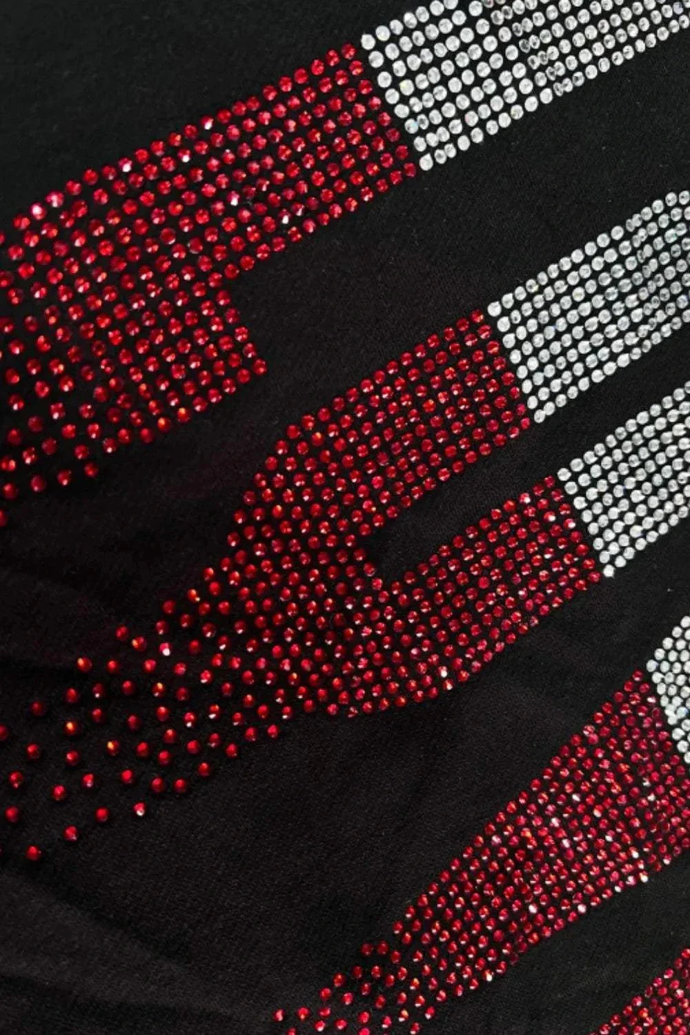 Close-up of black round neck sweatshirt with red and white rhinestone LOVE design