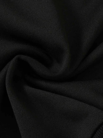 Close-up of black fabric texture for children's dinosaur sweatshirt set made of polyester and elastane blend