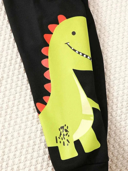 Children's dinosaur sweatshirt set with green dinosaur graphic on black pants.