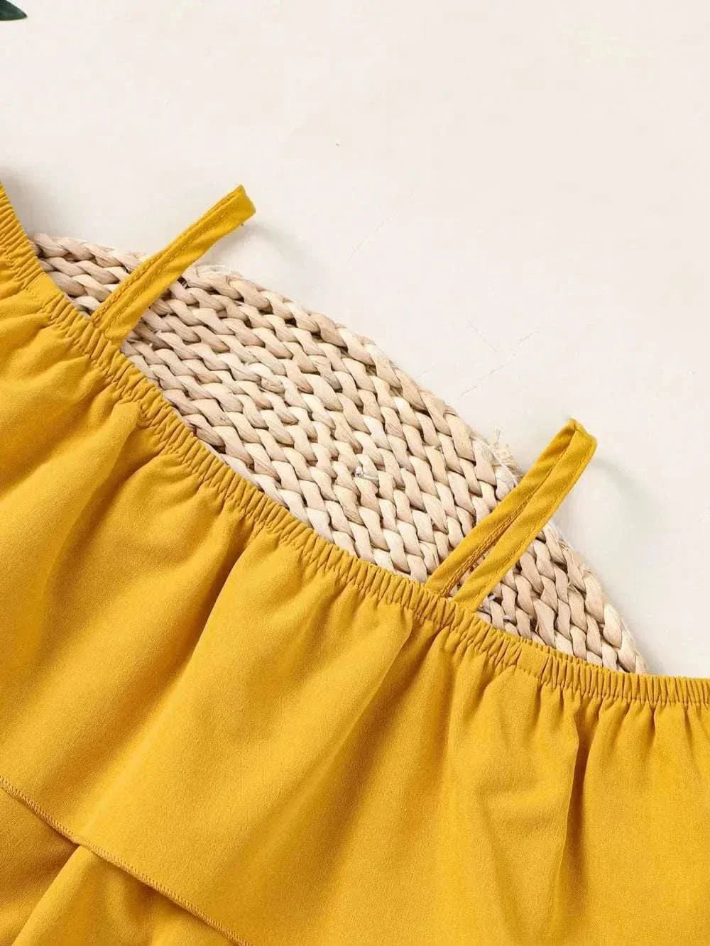Children's ruffled spaghetti strap top and pants set in mustard yellow polyester fabric designed for comfort and style.