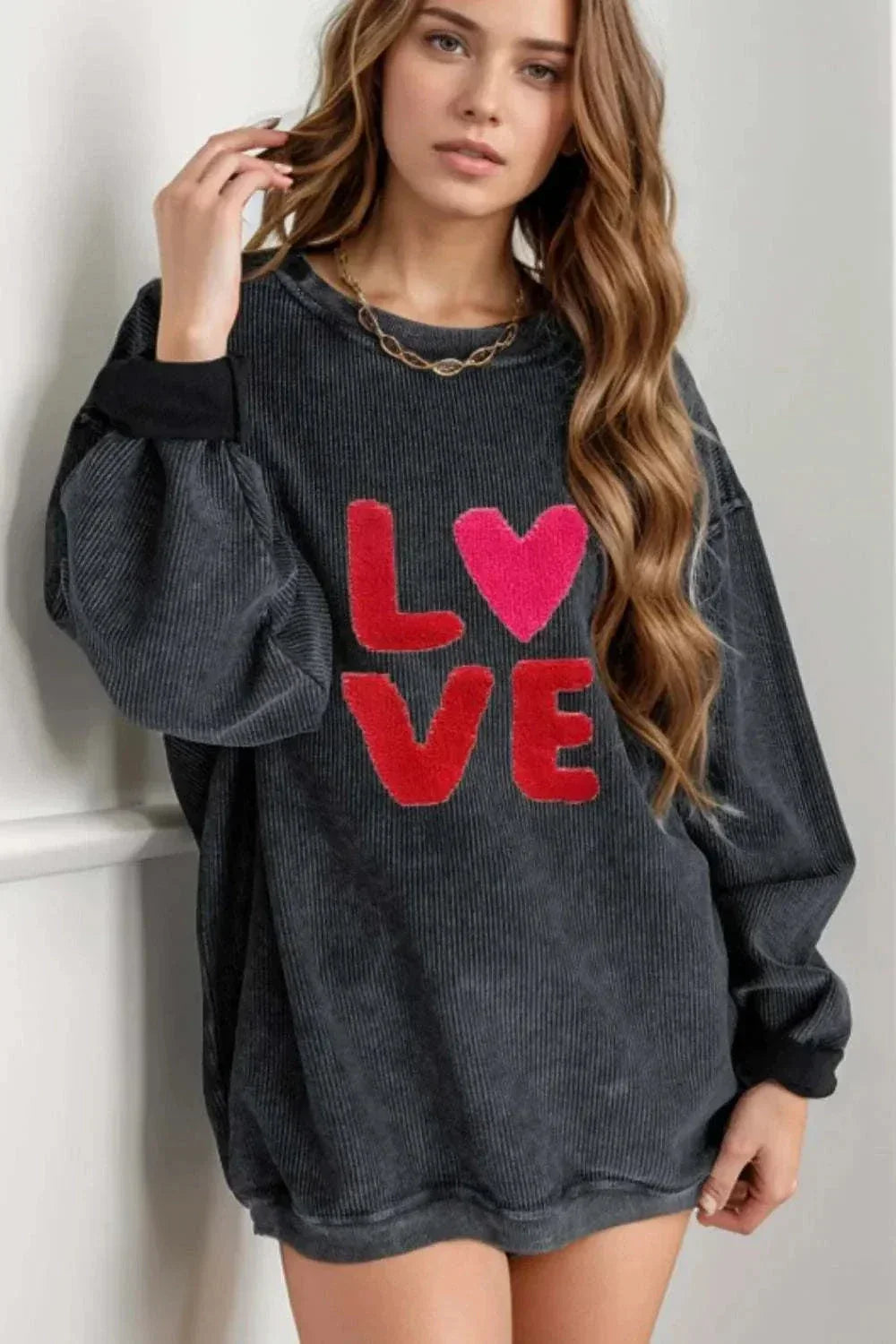 Valentine’s Day LOVE black long sleeve sweatshirt with red and pink LOVE lettering and round neck design