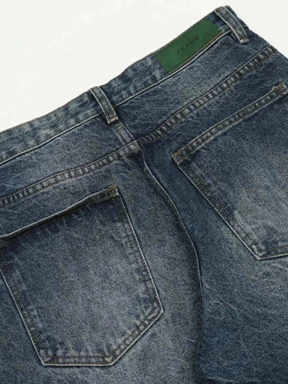 Close-up of back pockets on men's wide leg jeans in washed denim with a slight stretch blend
