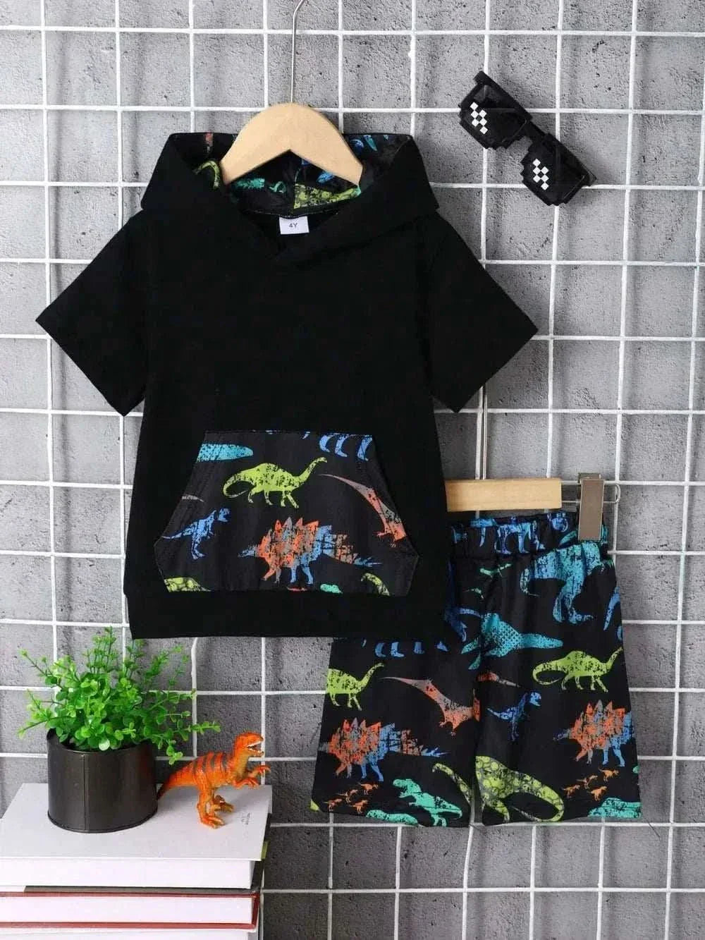 Children's dinosaur hooded short sleeve top and matching pants set with colorful dinosaur prints and pocket detailing.