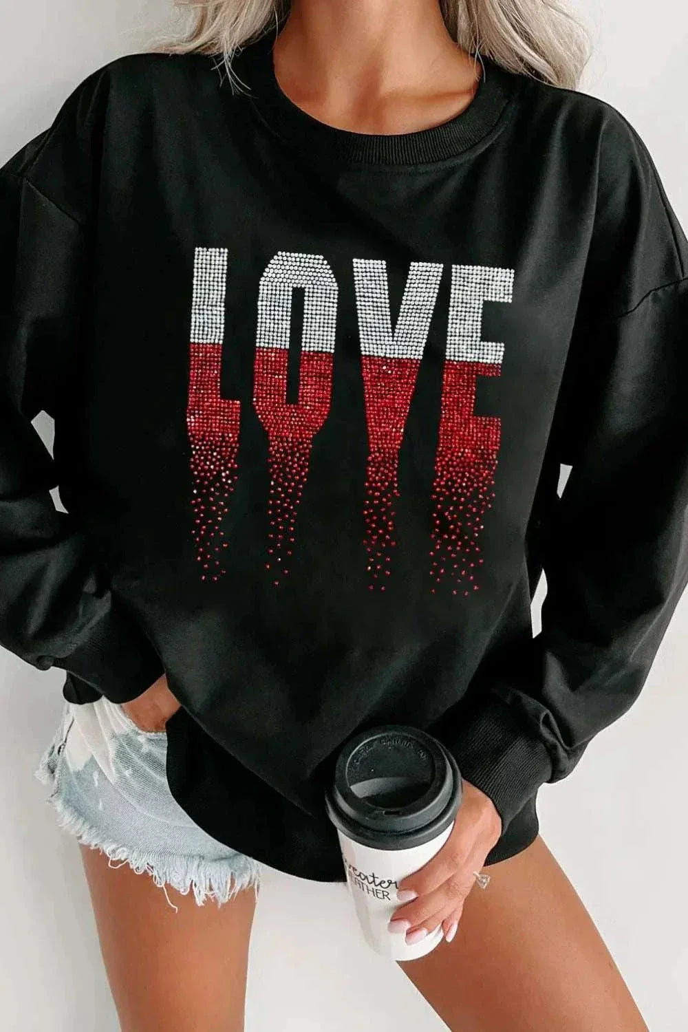 Black Rhinestone LOVE round neck long sleeve sweatshirt with red and silver rhinestone design on front.