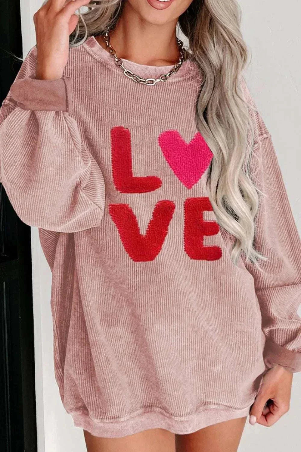 Valentine’s Day LOVE pink long sleeve sweatshirt with red and heart design, round neck, slightly stretchy polyester fabric