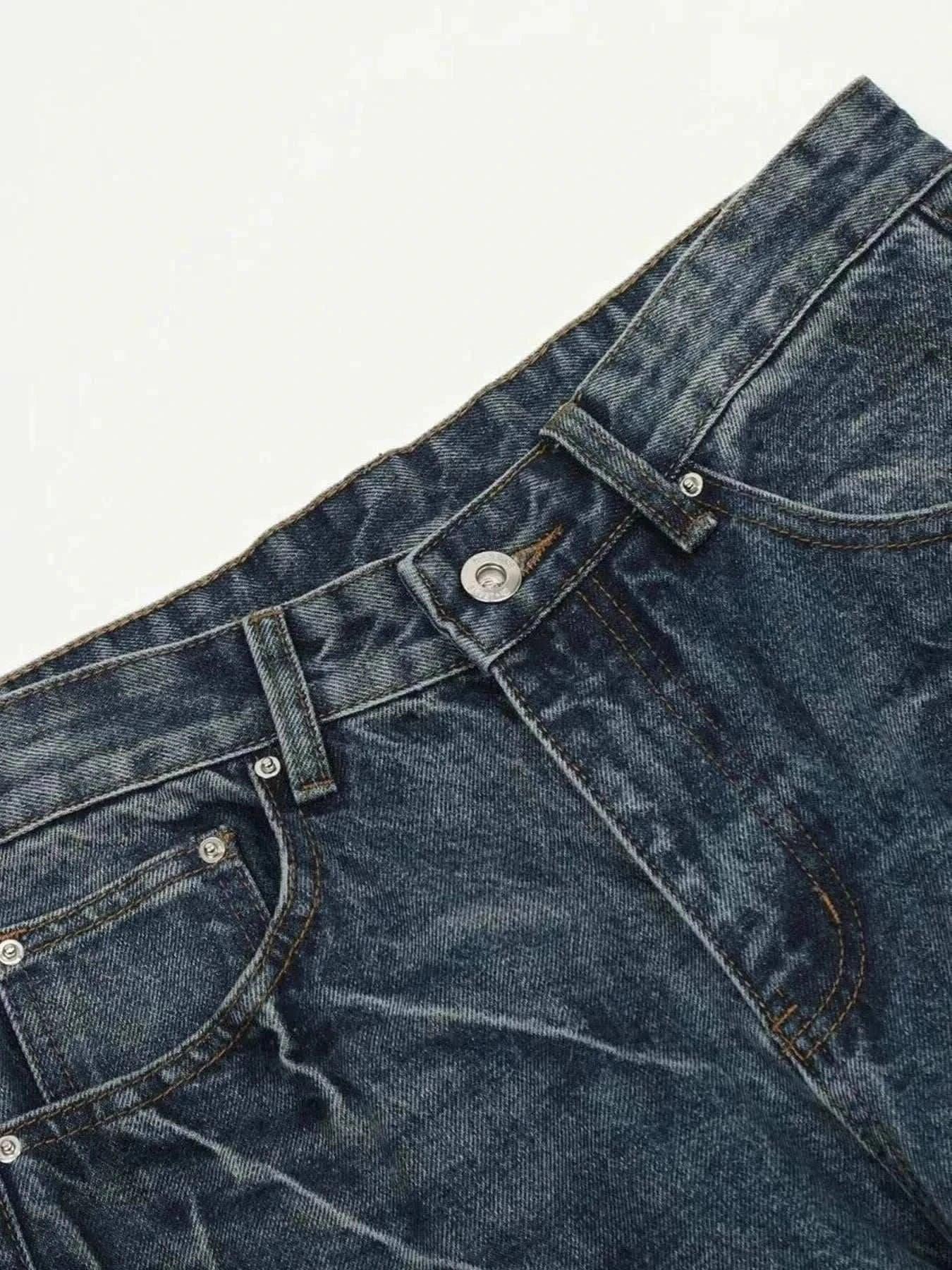 Close-up of dark washed men's wide leg jeans with cat's whisker details and slight stretch fabric