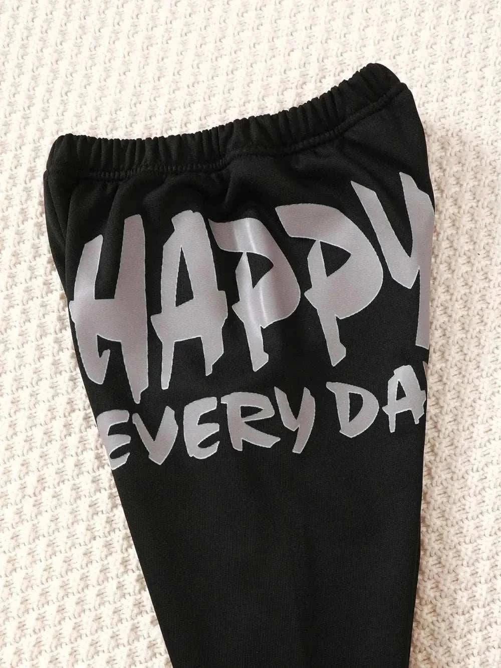 Black children's pants with "HAPPY EVERY DAY" text in gray from dinosaur sweatshirt set