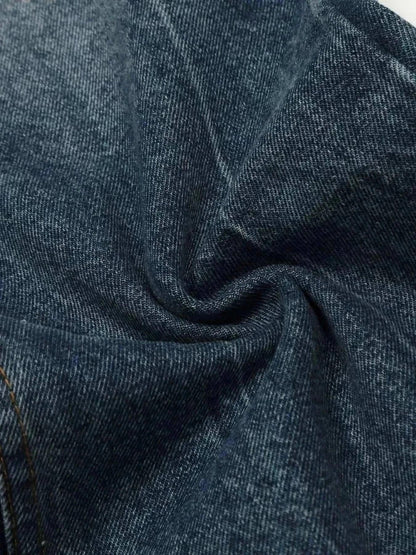 Close-up of dark blue denim fabric for men's wide leg jeans with slight texture and stretch.