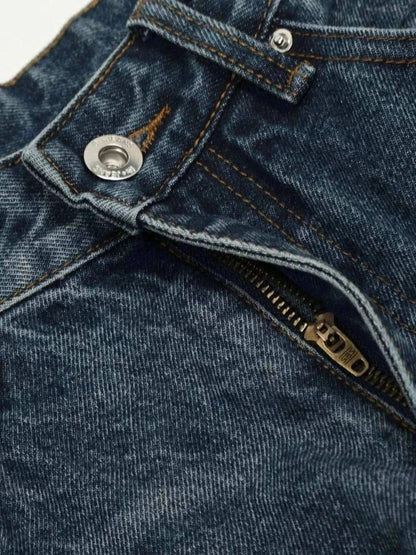 Close-up of dark washed men's wide leg jeans showing zipper and button details