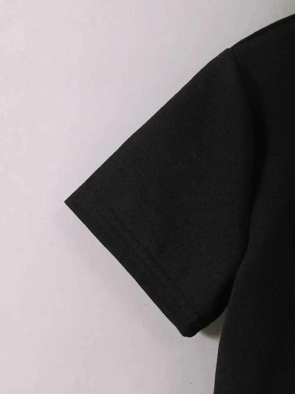 Close-up of black short sleeve on children's teddy bear round neck top and pants set made of polyester and elastane.